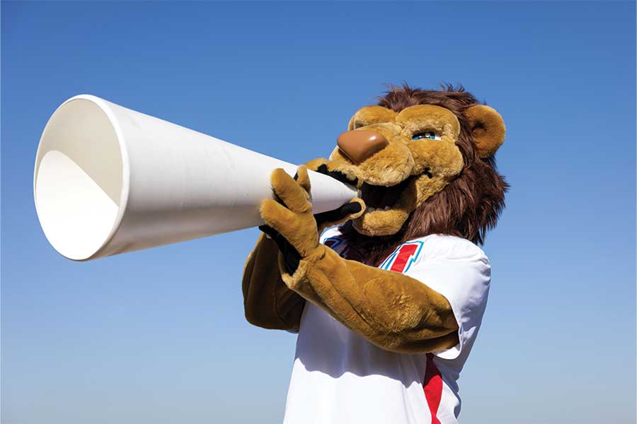 LMU mascot Iggy the Lion shouting through a horn
